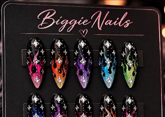 Dark jewel-toned nail design with ornate accents